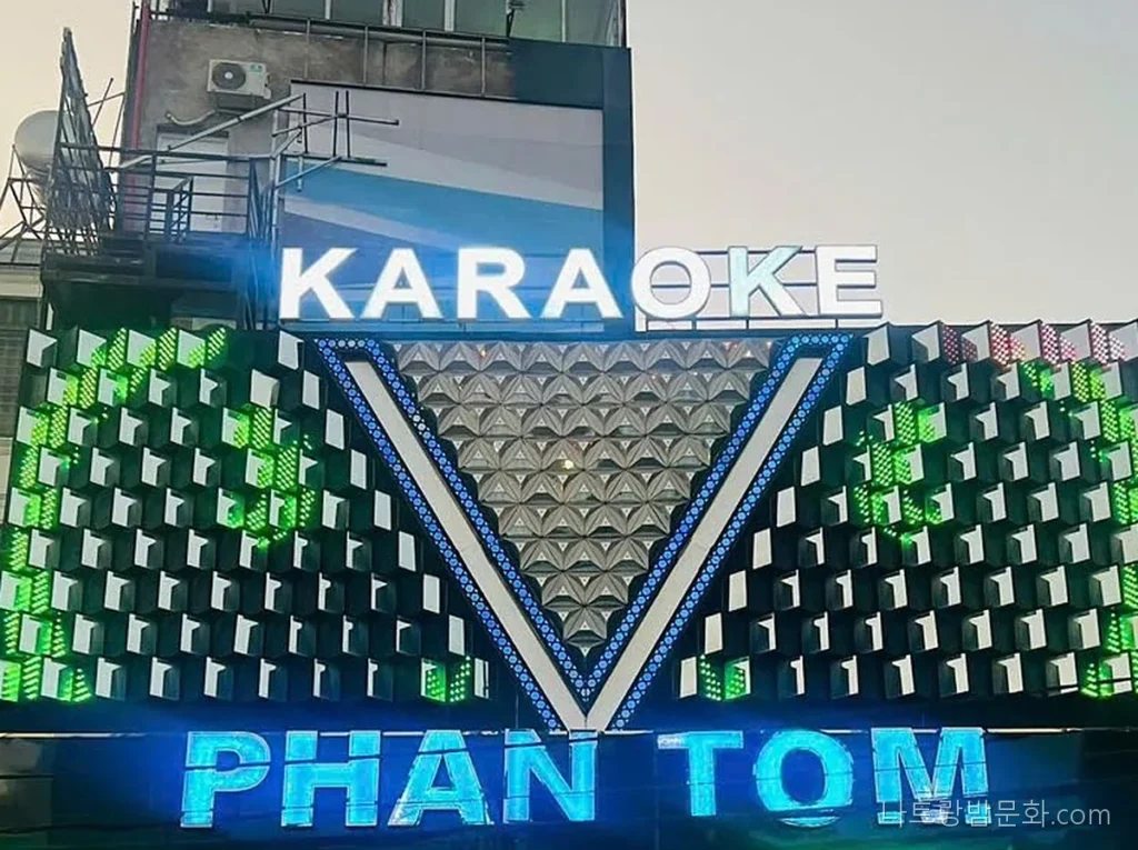 달랏 팬텀 가라오케 간판. KARAOKE 글자와 V자 LED 패널, 푸른 PHAN TOM 글자